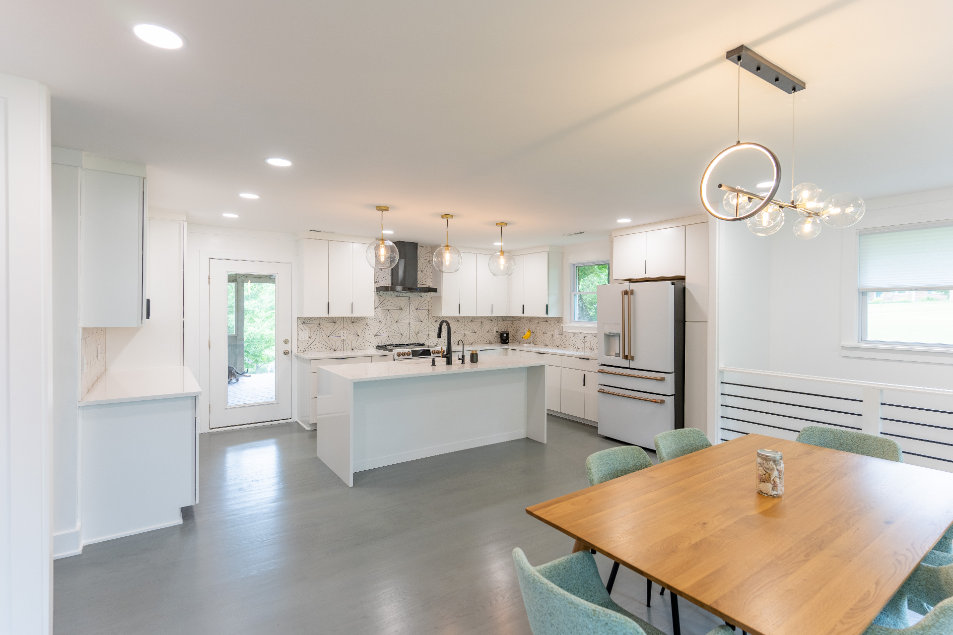Open kitchen and dining area with island and pendant lighting