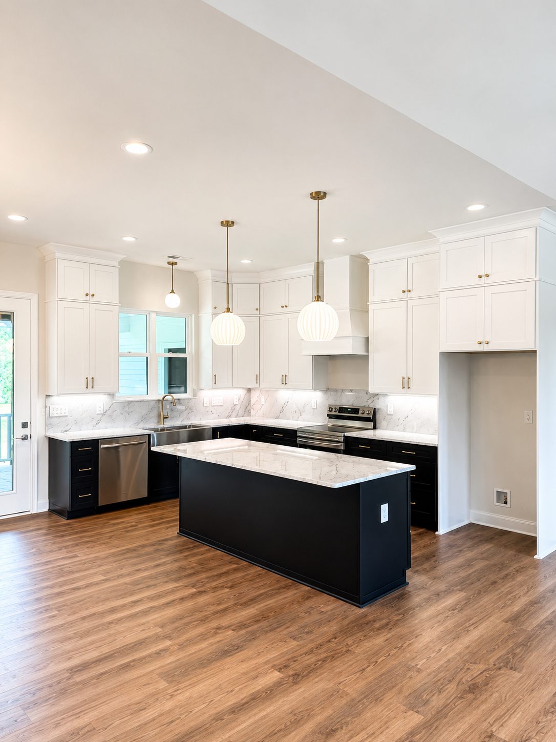 Open kitchen with black island, marble backsplash, and pendant lighting