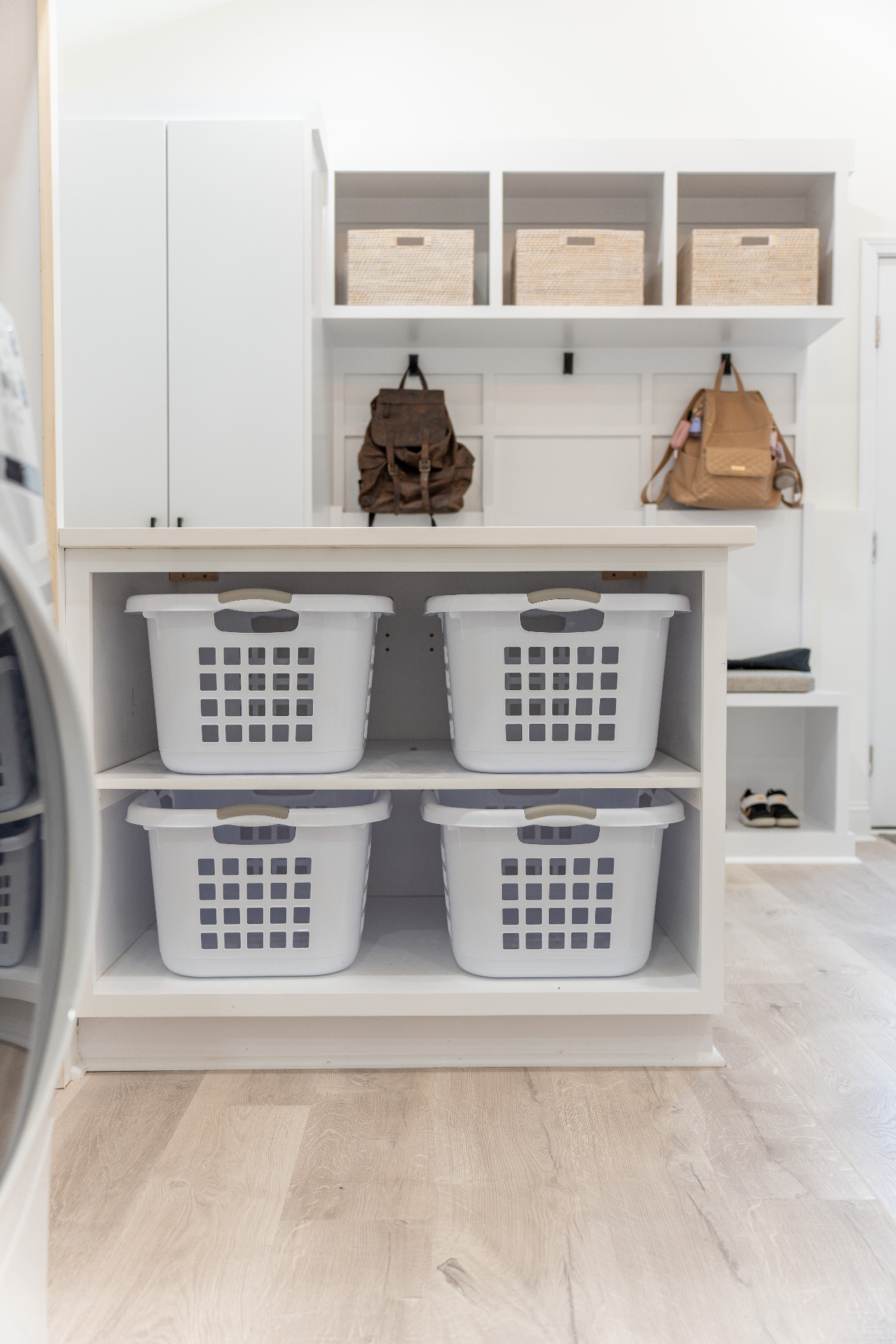 Laundry island with integrated basket storage and mudroom backdrop
