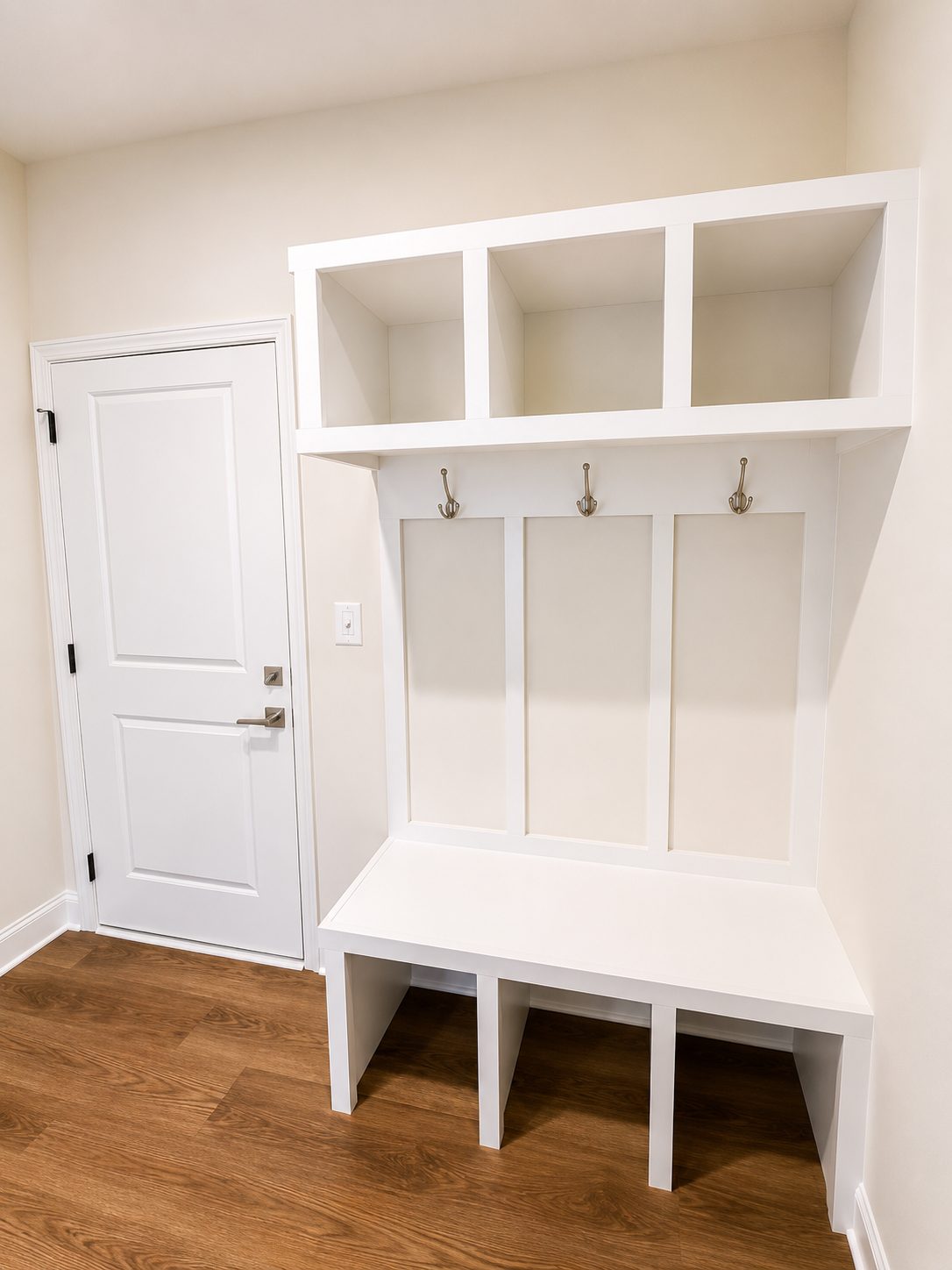 Built-in mudroom bench with cubbies, hooks, and upper storage